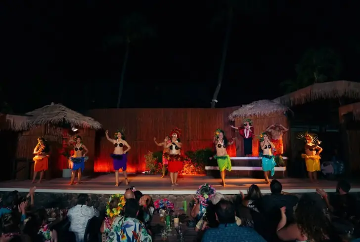 Maui luau performers entertaining family audience
