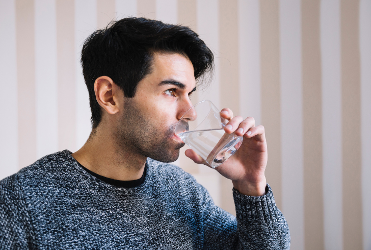 Traveler drinking water after food illness